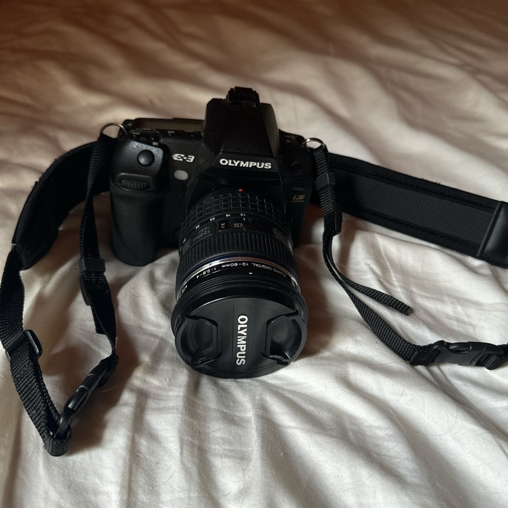Working Olympus camera with hood and cap
